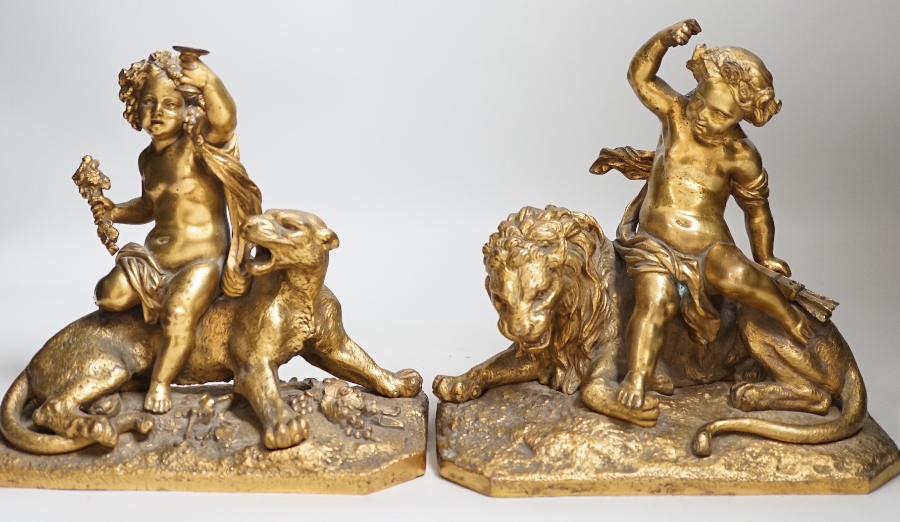 A pair of 19th century gilt metal cherub groups, 20cm tall